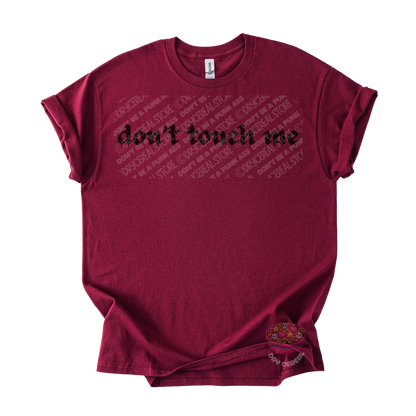 Maroon unisex tee featuring the phrase "don't touch me" in bold gothic black lettering across the chest.