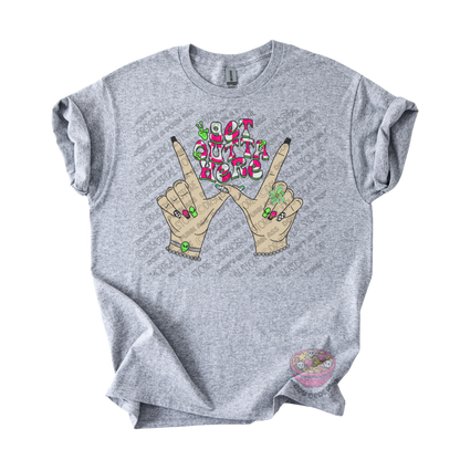 Light gray unisex T-shirt featuring the phrase "Get Outta Here" above Y2K-inspired hands making the iconic gesture with colorful nails, alien accents, bracelets, and retro lettering.