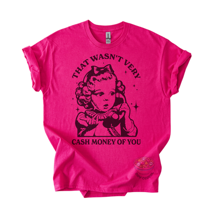 A bright pink short-sleeve graphic t-shirt featuring a black retro-style illustration of a woman on a telephone with the text 'THAT WASN'T VERY CASH MONEY OF YOU' printed on the front.