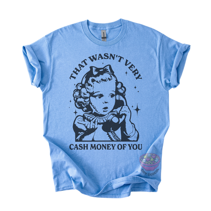 A light blue short-sleeve t-shirt with a black graphic print of a vintage-style cartoon girl holding a telephone, with the text 'THAT WASN'T VERY CASH MONEY OF YOU' printed around her. 