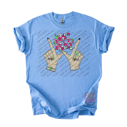 Light blue unisex T-shirt featuring the phrase "Get Outta Here" above Y2K-inspired hands making the iconic gesture with colorful nails, alien accents, bracelets, and retro lettering.