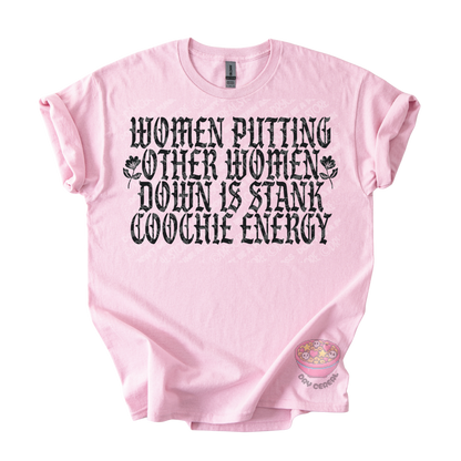 A light pink short-sleeve t-shirt with a black graphic text print that reads 'WOMEN PUTTING OTHER WOMEN DOWN IS STANK COOCHE ENERGY' accompanied by small floral illustrations. 