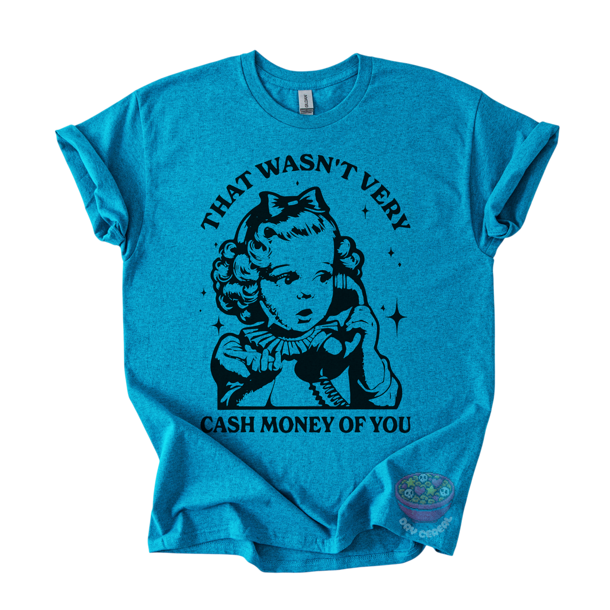 A teal short-sleeve t-shirt with a black graphic print of a retro-style young girl holding a telephone, with the text 'THAT WASN'T VERY CASH MONEY OF YOU' arched above and below the illustration.