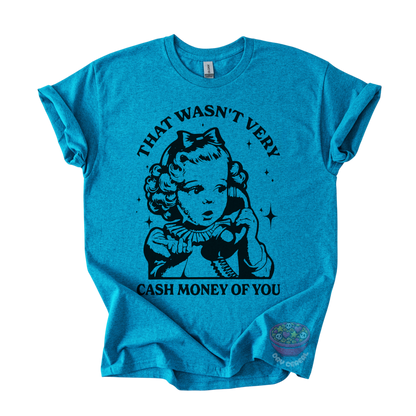 A teal short-sleeve t-shirt with a black graphic print of a retro-style young girl holding a telephone, with the text 'THAT WASN'T VERY CASH MONEY OF YOU' arched above and below the illustration.