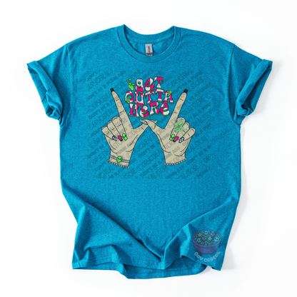 Turquoise blue unisex T-shirt featuring the phrase "Get Outta Here" above Y2K-inspired hands making the iconic gesture with colorful nails, alien accents, bracelets, and retro lettering.