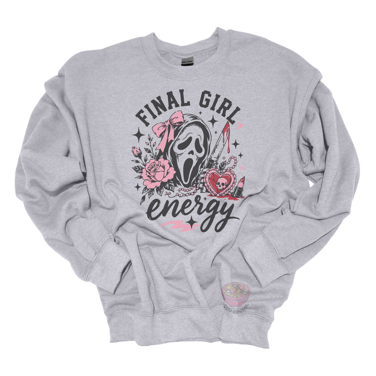 Gray crewneck sweatshirt featuring a horror-inspired ghost mask design with pink roses, a bloody knife, heart locket, lipstick, and the phrase "Final Girl Energy."