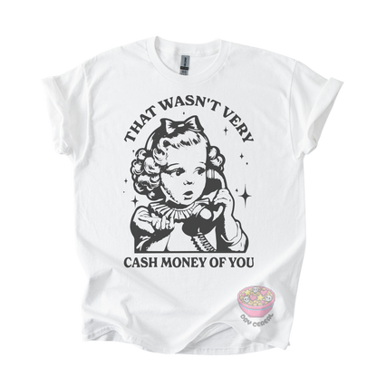 A white short-sleeve graphic t-shirt featuring a black retro-style illustration of a young girl holding a telephone receiver, with the text 'THAT WASN'T VERY CASH MONEY OF YOU' printed around the graphic. 