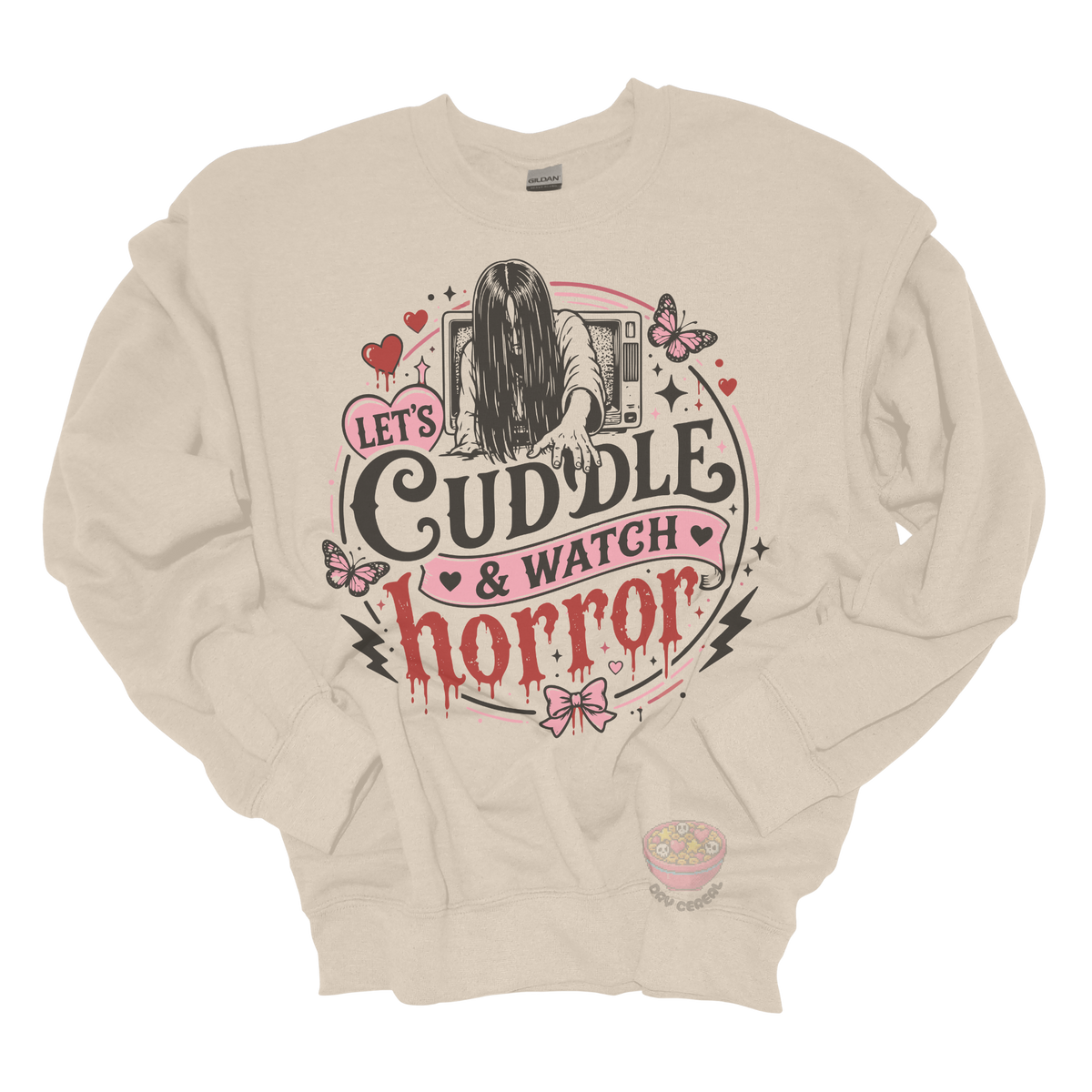 Beige crewneck sweatshirt featuring a spooky cute horror-inspired design with the phrase "Let's Cuddle & Watch Horror," pink hearts, butterflies, bows, and a creepy long-haired figure emerging from a television.