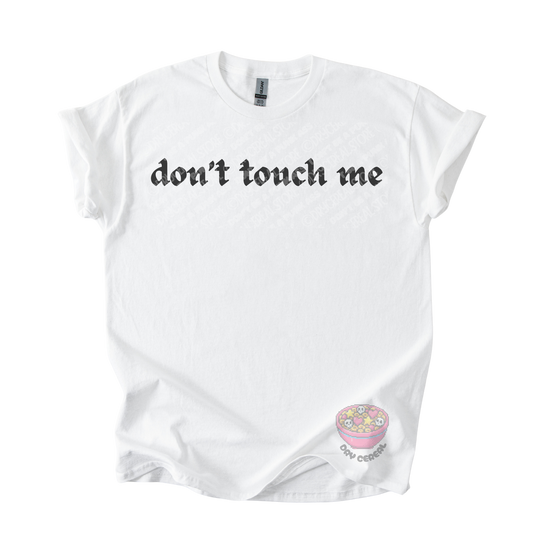 White unisex tee featuring the phrase "don't touch me" in bold gothic black lettering across the chest.