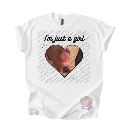 White unisex T-shirt featuring the phrase "I'm just a girl" above an original heart-shaped collage graphic with an edgy alternative aesthetic