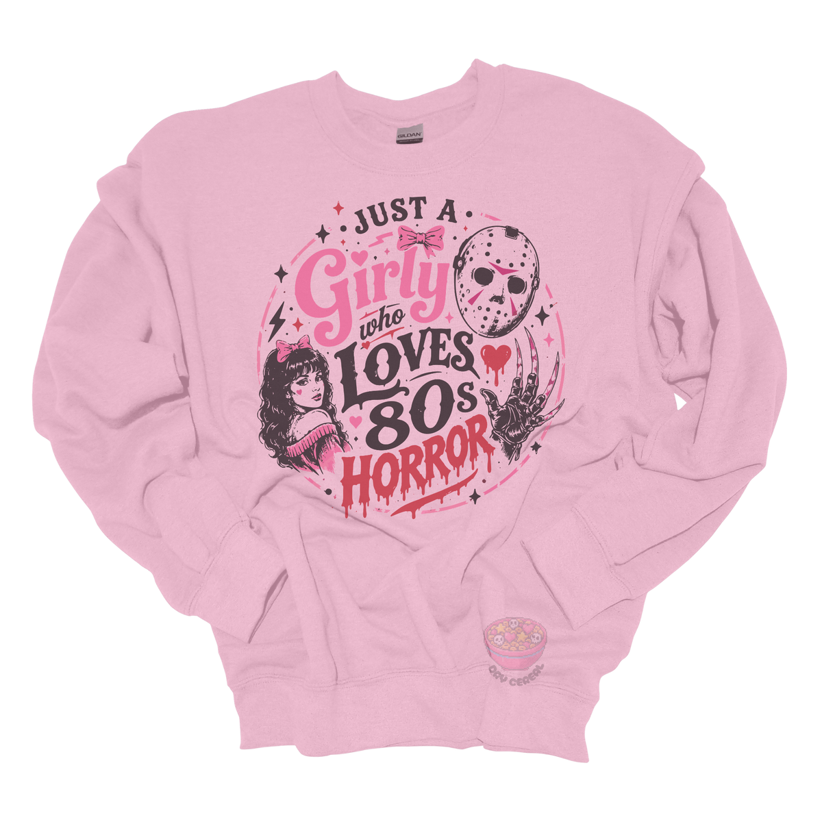 Light pink crewneck sweatshirt featuring the phrase "Just a Girly Who Loves 80s Horror" with retro horror-inspired artwork including a hockey mask, clawed glove, vintage girl illustration, pink bows, and spooky accents.