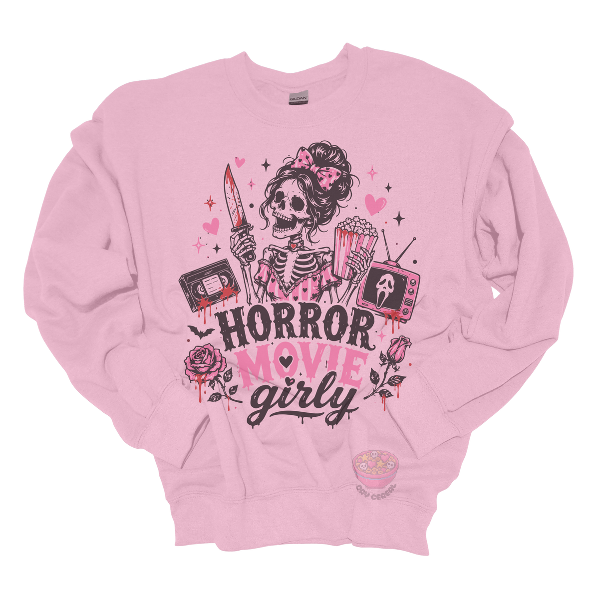Light pink crewneck sweatshirt featuring a skeleton with a pink bow holding a bloody knife and popcorn, surrounded by horror-inspired movie details, roses, hearts, a VHS tape, retro television, and the phrase "Horror Movie Girly."