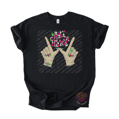 Black unisex T-shirt featuring the phrase "Get Outta Here" above Y2K-inspired hands making the iconic gesture with colorful nails, alien accents, bracelets, and retro lettering.