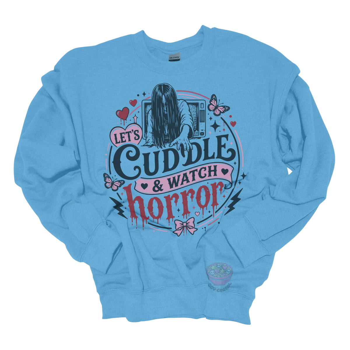 Light blue crewneck sweatshirt featuring a spooky cute horror-inspired design with the phrase "Let's Cuddle & Watch Horror," pink hearts, butterflies, bows, and a creepy long-haired figure emerging from a television.