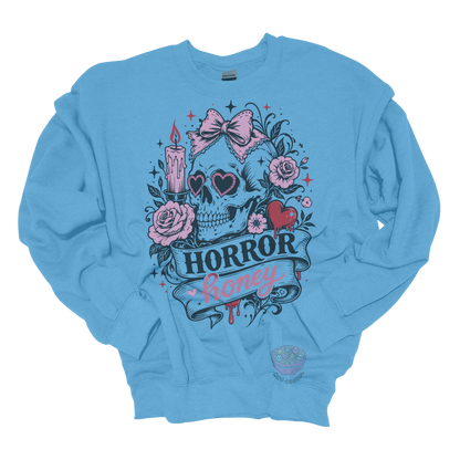 Light blue crewneck sweatshirt featuring a vintage skull with heart-shaped sunglasses, pink bow, roses, candle, dripping heart, and the phrase "Horror Honey" in a spooky gothic design.
