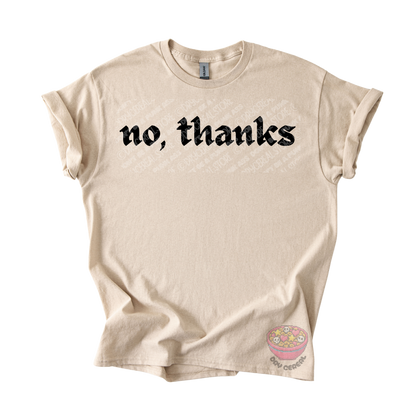Sand unisex T-shirt featuring the phrase "No, thanks" in bold black gothic lettering across the chest.