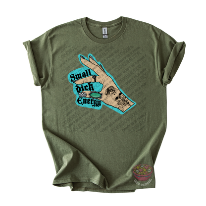 An olive green graphic t-shirt featuring a hand graphic with the text 'Small dick Energy' in black and teal,.