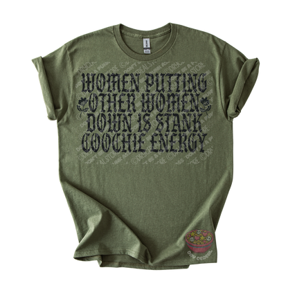 An olive green graphic t-shirt with a distressed black text print that reads 'WOMEN PUTTING OTHER WOMEN DOWN IS STANK COOCHE ENERGY'. 
