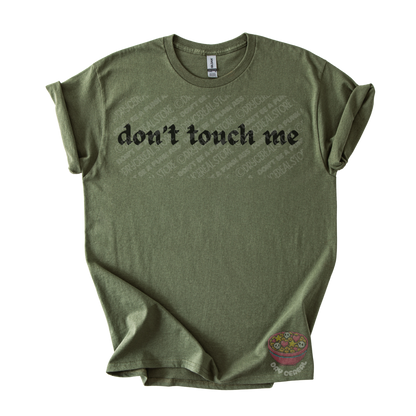 Olive green unisex tee featuring the phrase "don't touch me" in bold gothic black lettering across the chest.