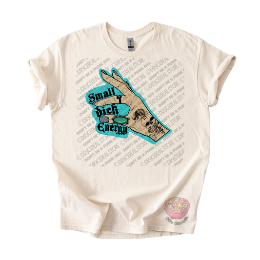 An off-white short-sleeve graphic t-shirt featuring a central design of a hand with a skull tattoo and a turquoise speech bubble that reads 'Small dick Energy'. 