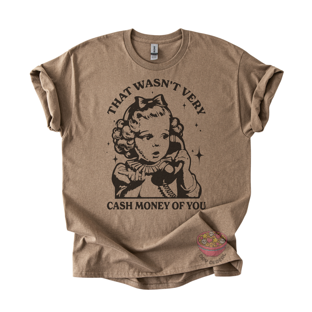 A brown graphic t-shirt featuring a vintage-style illustration of a girl with a bow and the text 'THAT WASN'T VERY CASH MONEY OF YOU'.