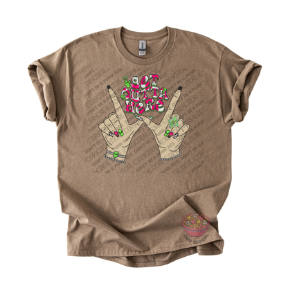 Light brown unisex T-shirt featuring the phrase "Get Outta Here" above Y2K-inspired hands making the iconic gesture with colorful nails, alien accents, bracelets, and retro lettering.